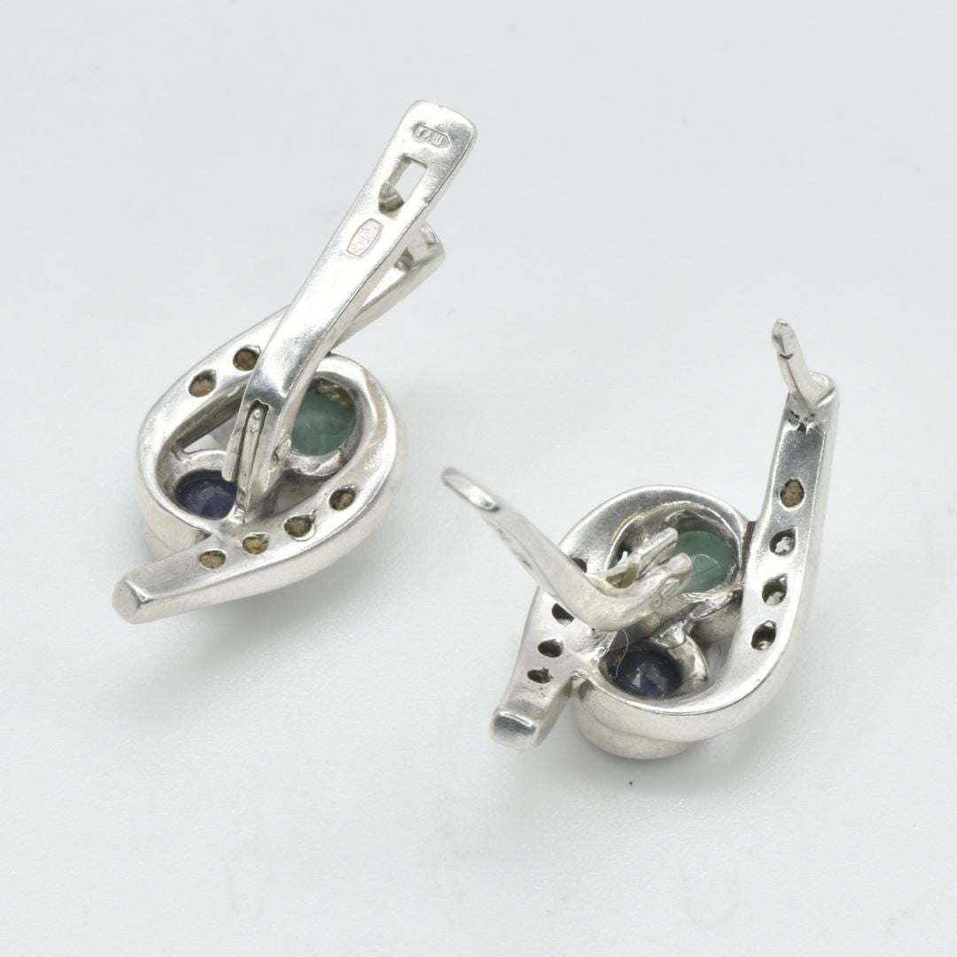 An elegant woman smiling while wearing a stunning Adina Stone necklace, showcasing its intricate design against a soft background.