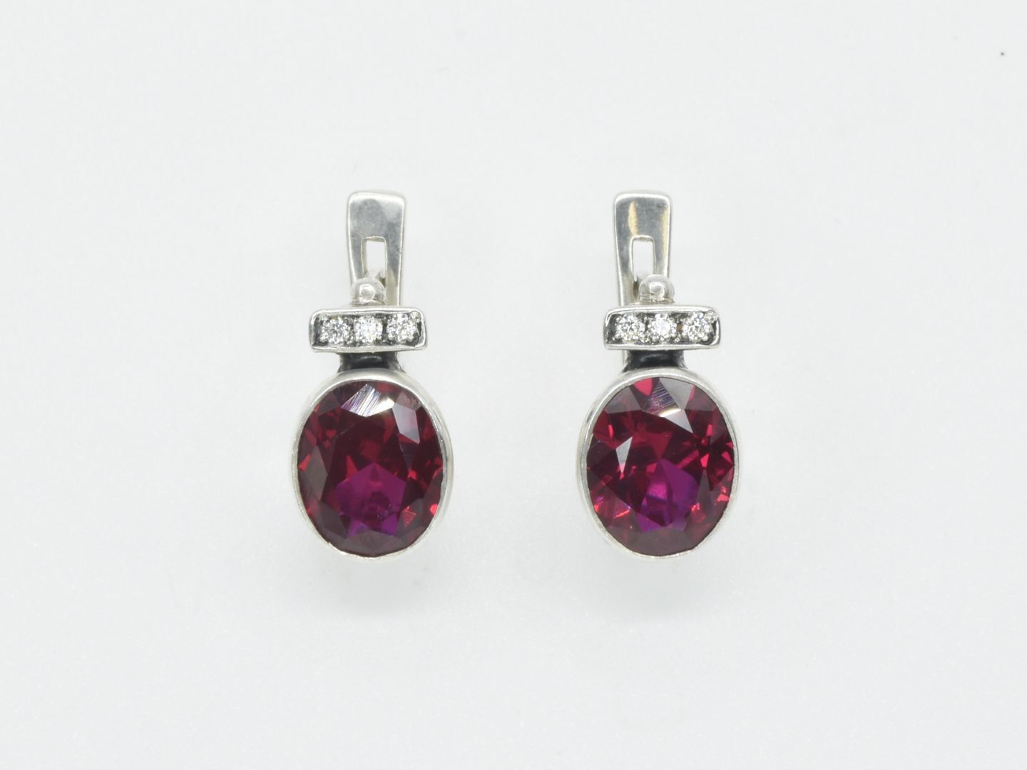 Created Ruby Earrings made in 925 Sterling Silver with Oval Created Red Ruby in Bezel setting, July Birthstone gift idea, symbolizes nobility, purity, and passion, ideal for everyday wear and perfect for birthday gifting and special occasions.