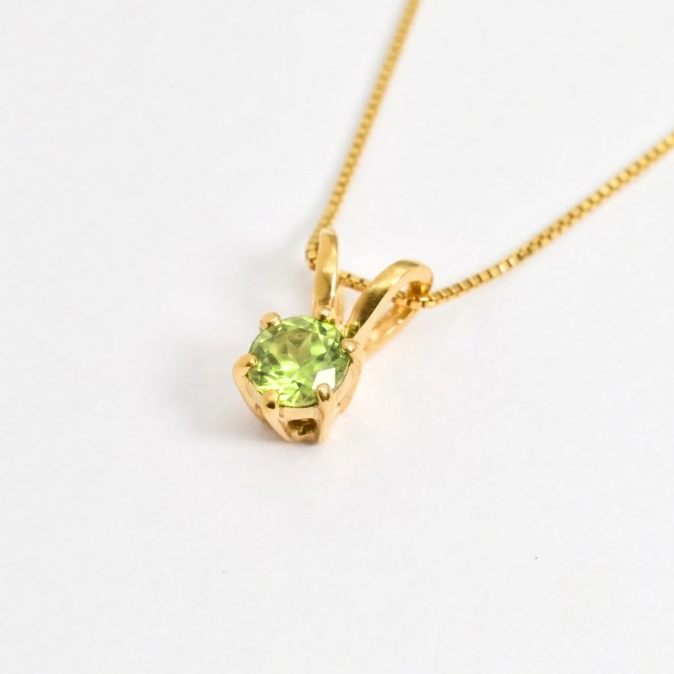 Round peridot birthstone pendant on 18k gold vermeil chain, styled on a model for everyday wear and special occasions