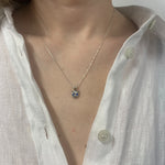 Elegant created sapphire pendant in 925 sterling silver, showcasing a round blue sapphire, symbolizes loyalty and truth.