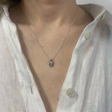Elegant created sapphire pendant in 925 sterling silver, showcasing a round blue sapphire, symbolizes loyalty and truth.