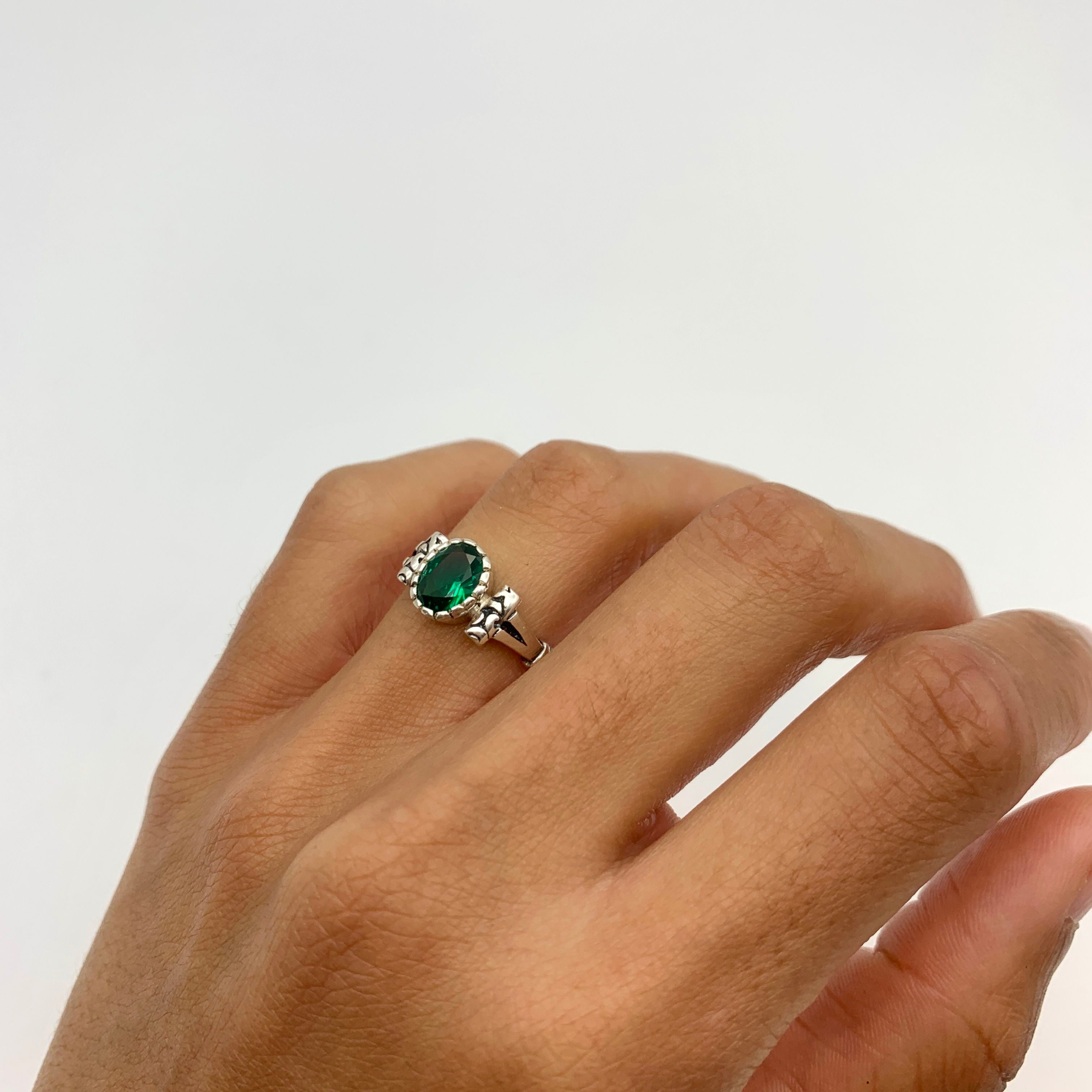 Elegant 925 Sterling Silver ring featuring a stunning oval Created Green Emerald, perfect for May birthdays and special occasions.