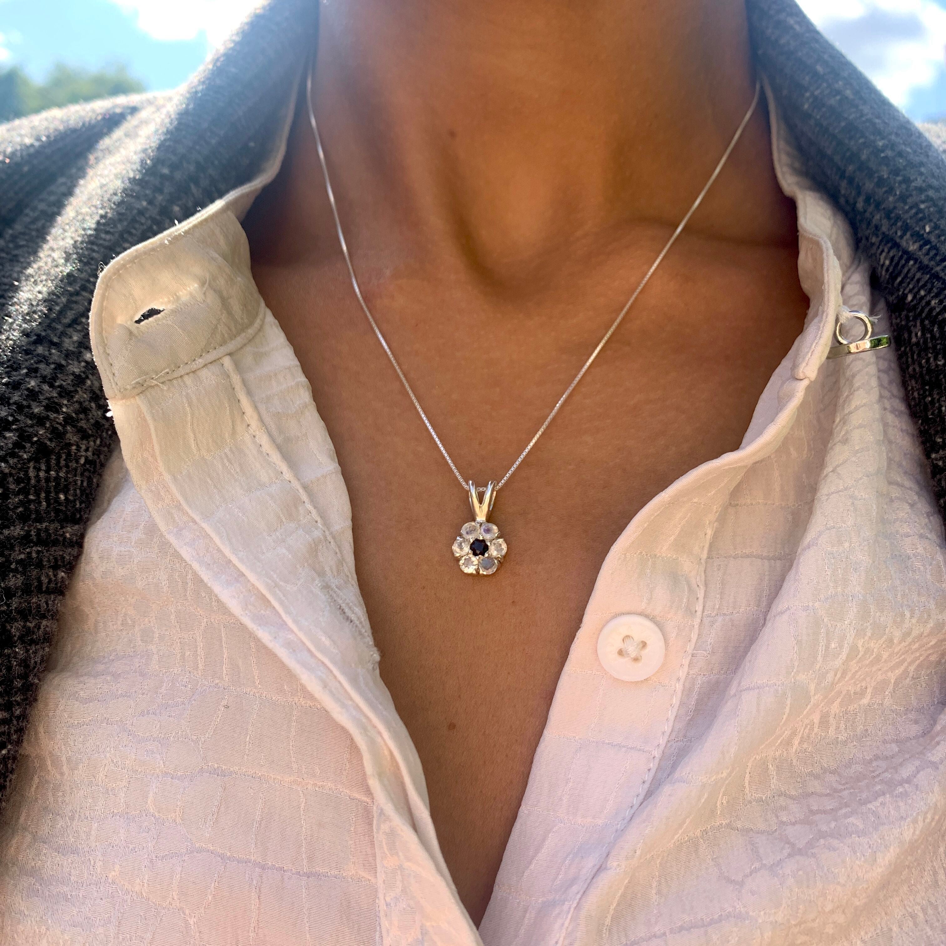 Moonstone Flower Pendant - Elegant sapphire accents on a white flower design, crafted in 925 sterling silver for everyday elegance.