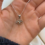 Silver Eye Pendant on palm