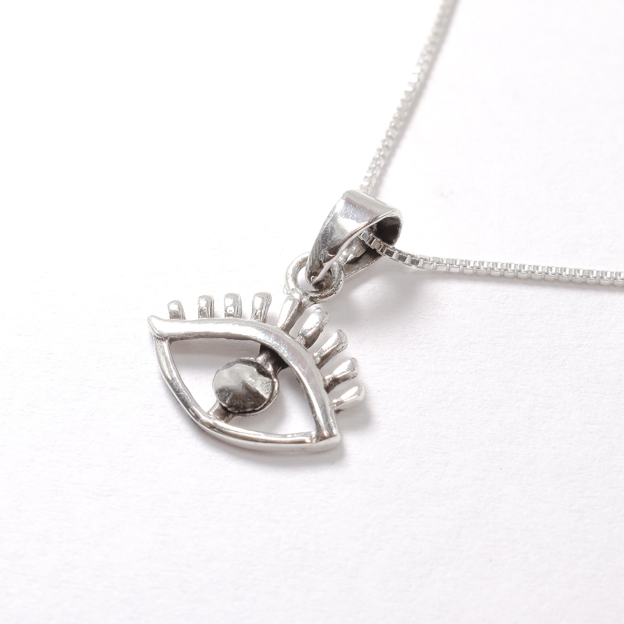Silver Eye Pendant Angled View in White Background