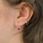 A close-up of elegant Adina Stone Jewelry showcasing intricate details and sparkling gemstones on a soft velvet background.