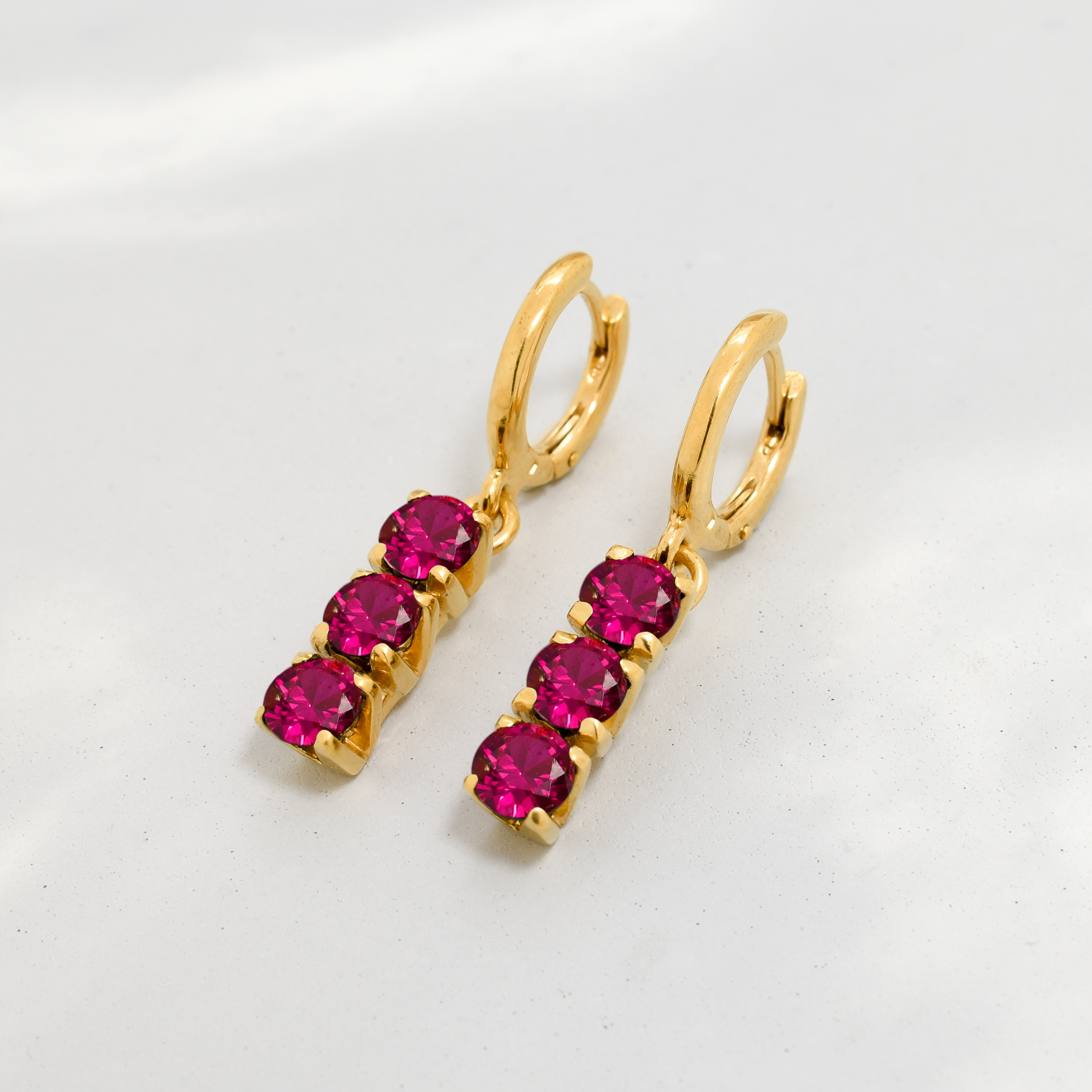 Chic 18k Gold Vermeil Earrings with a radiant Round Created Red Ruby, perfect for adding a touch of elegance to any outfit.