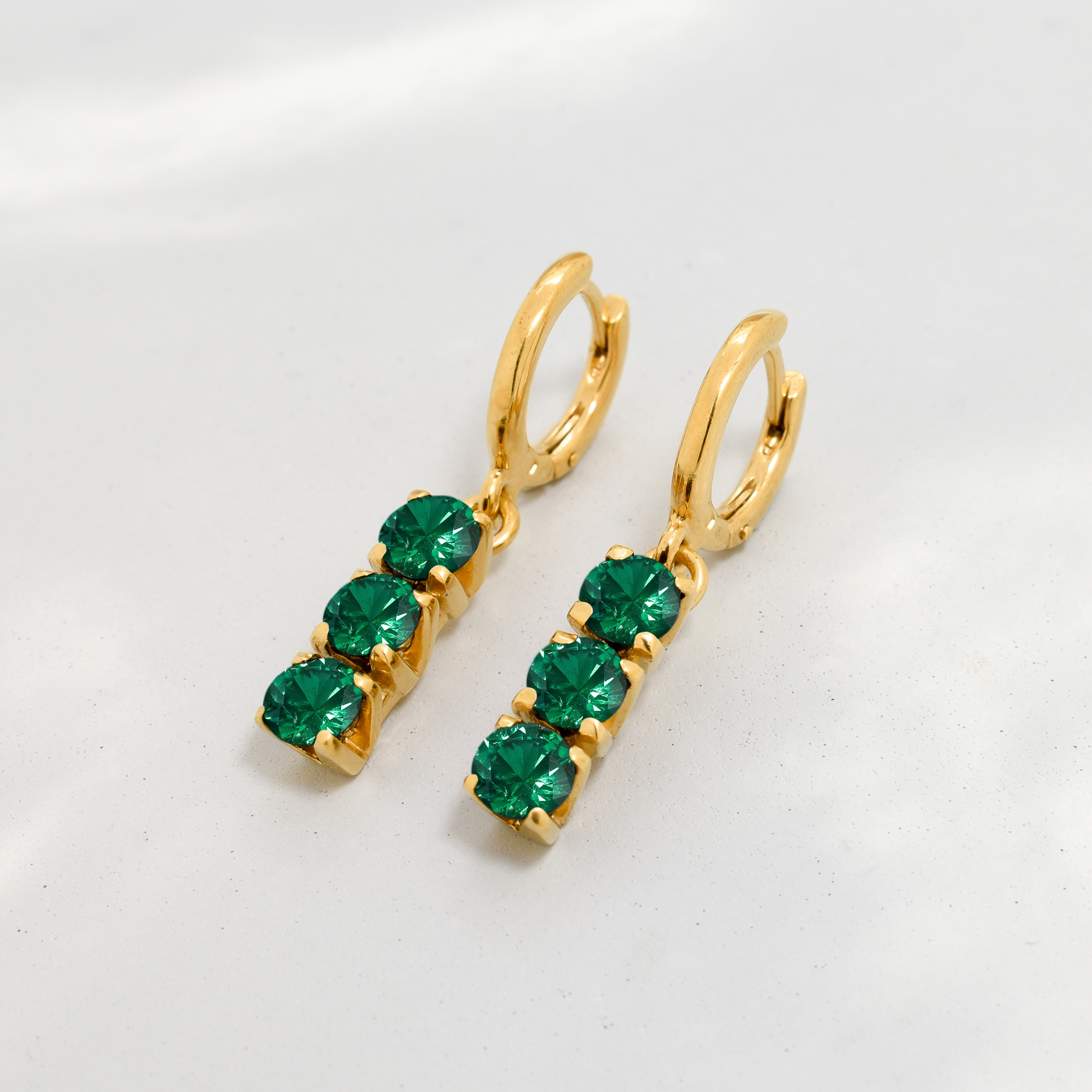 Chic 18k Gold Vermeil Emerald Earrings with a Three-Stone design, a timeless May birthstone piece for all occasions.