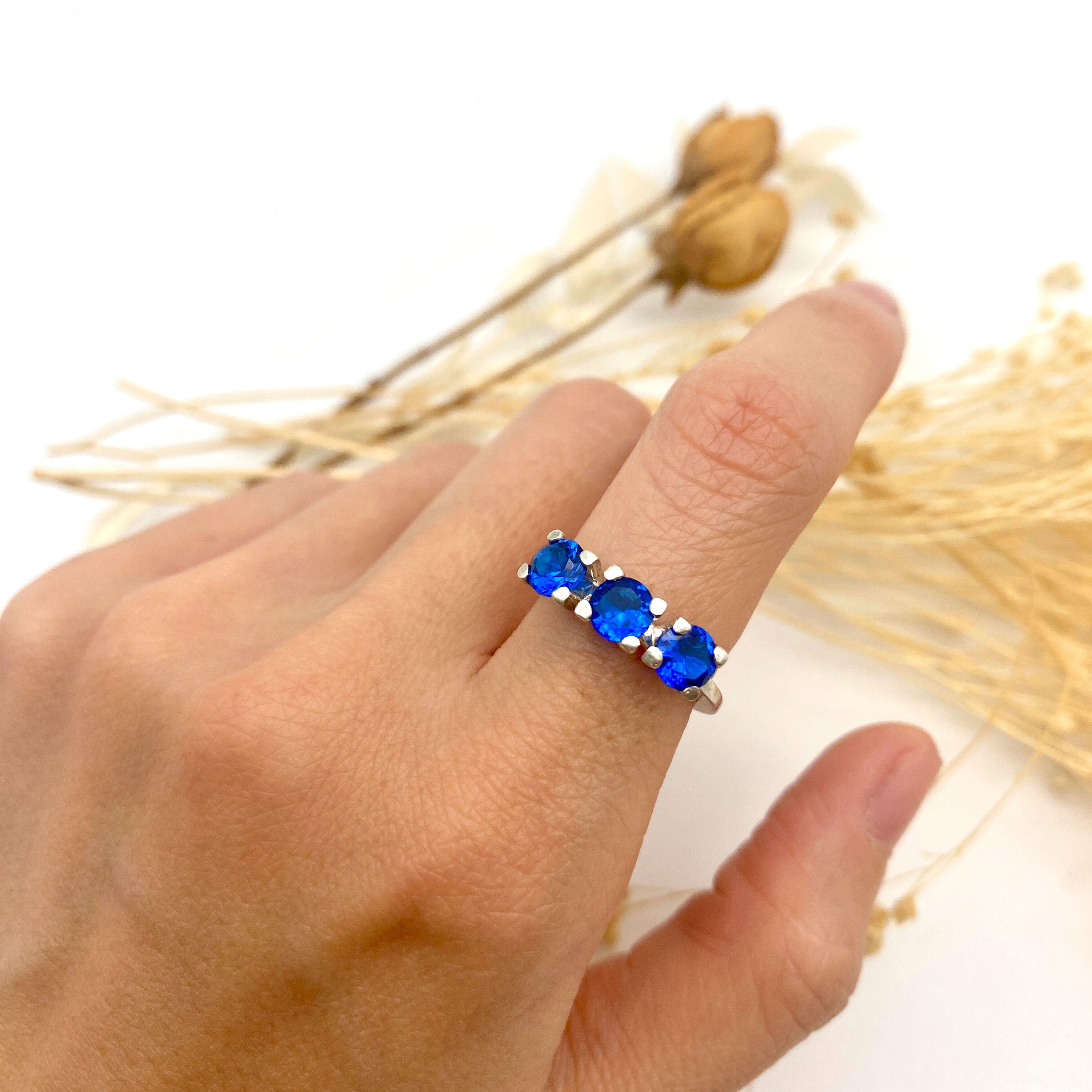 Gorgeous three-stone ring in 925 Sterling Silver, showcasing a beautiful Created Blue Sapphire, perfect for meaningful gifts.