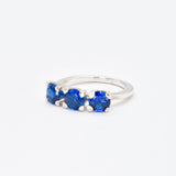 Stylish three-stone sterling silver ring with a vibrant round Created Blue Sapphire, ideal for gifting and daily wear.