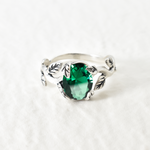 Beautiful oval created emerald in a unique prong setting, crafted in 925 Sterling Silver for a timeless look.