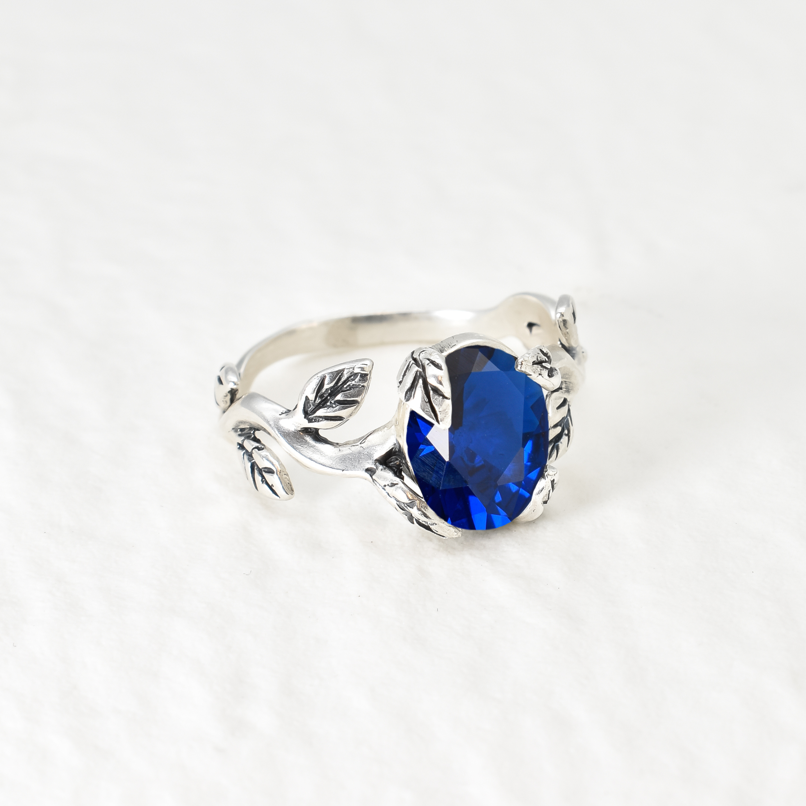 Stylish 925 Sterling Silver Ring with a captivating Oval Created Blue Sapphire, an ideal gift for the September-born.