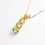 Gold Peridot Necklace Angled View in White Background