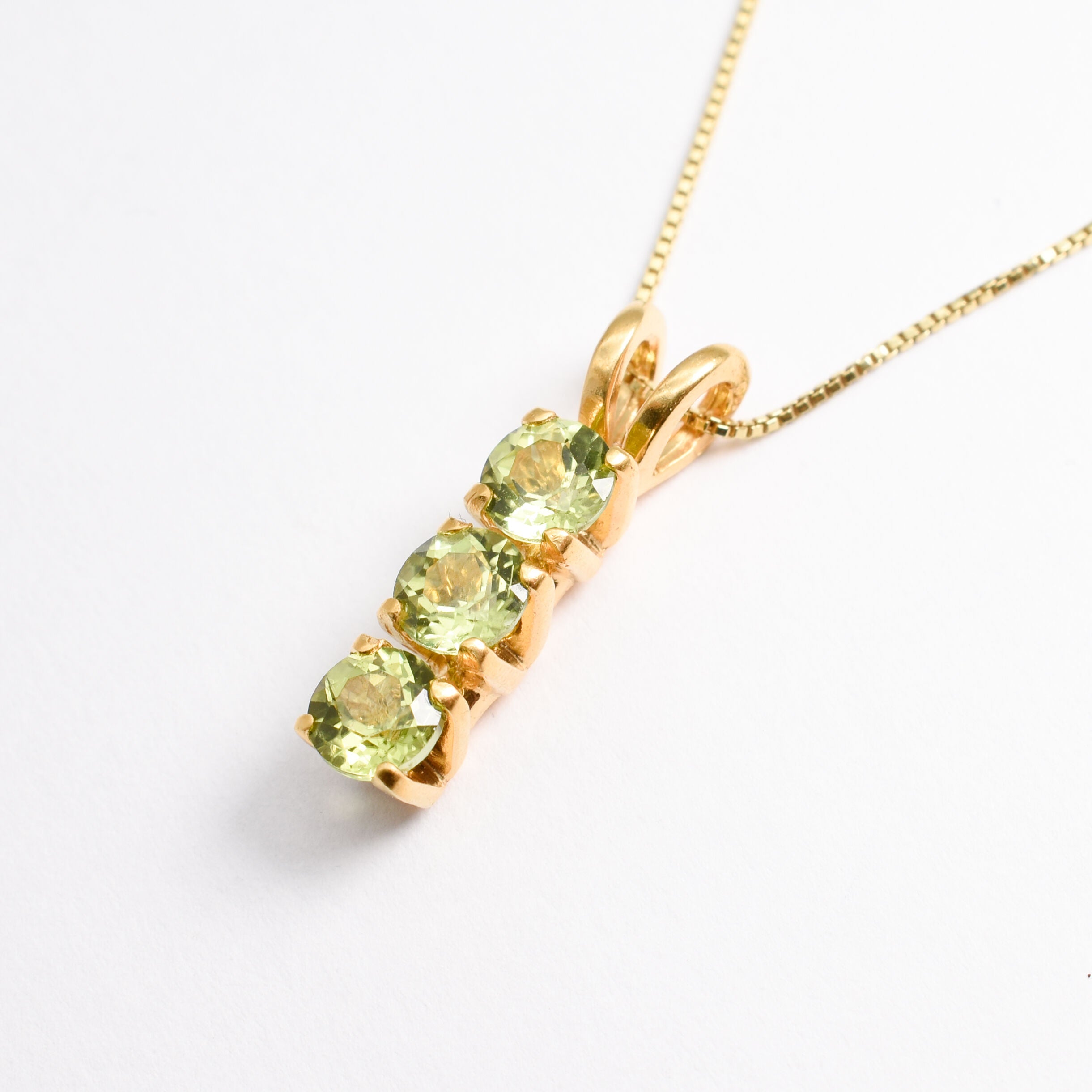 Gold Peridot Necklace Angled View in White Background