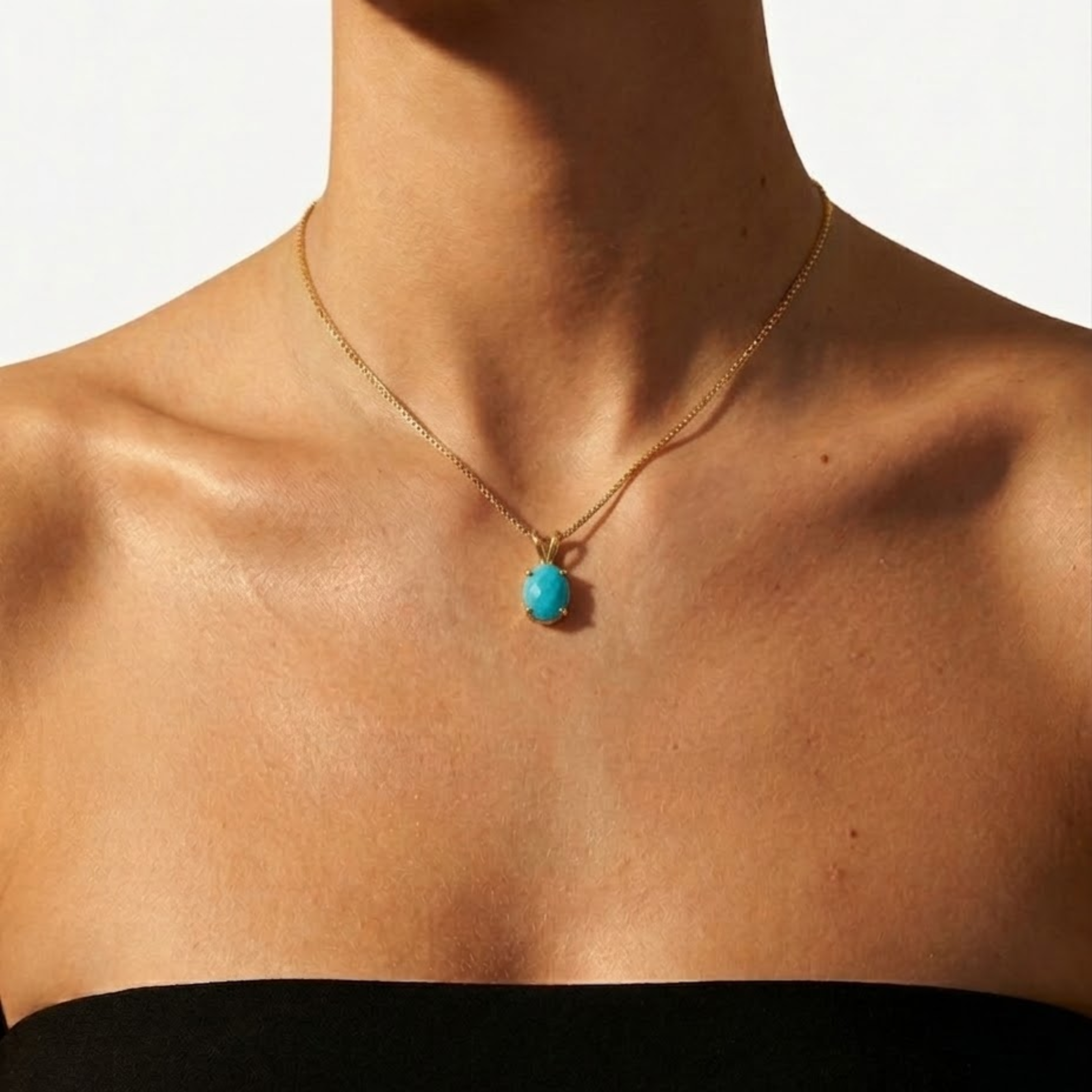 Close-up of 18k gold vermeil pendant with blue turquoise in prong setting, December birthstone for protection and healing