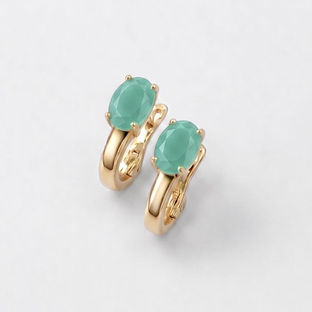 Oval green emerald earrings in 18k gold vermeil, prong-set May birthstone symbolizing growth and harmony.