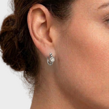 Model wearing small 925 sterling silver white topaz huggie hoops with clear oval stones and textured rope bands, perfect for minimalist, bridal and occasion jewelry; white topaz is linked with clarity and positive energy.