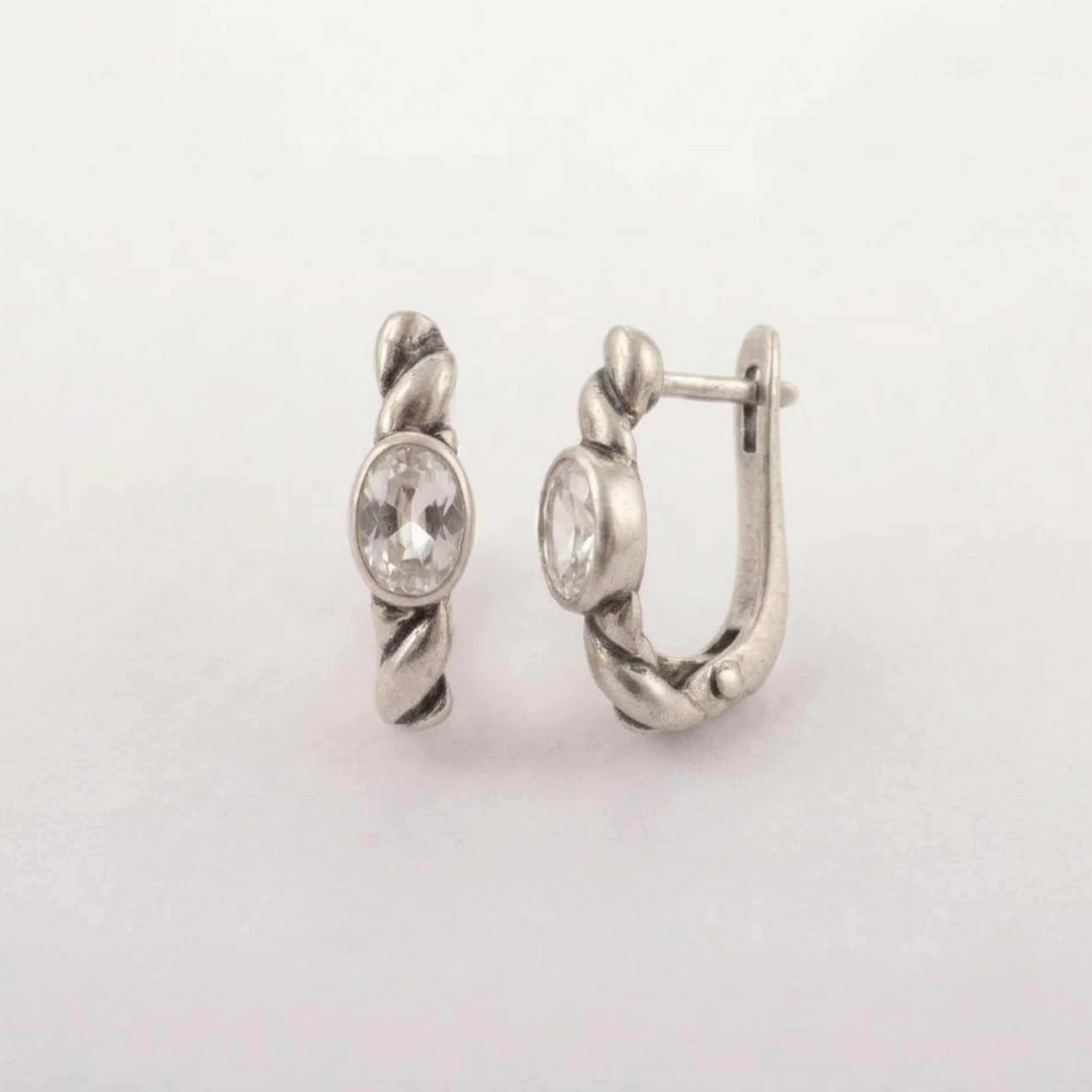 925 sterling silver huggie hoop earrings with clear white topaz, twisted rope texture and bezel-set oval stones, ideal for birthdays, bridal looks and everyday wear; white topaz is associated with clarity and intention.