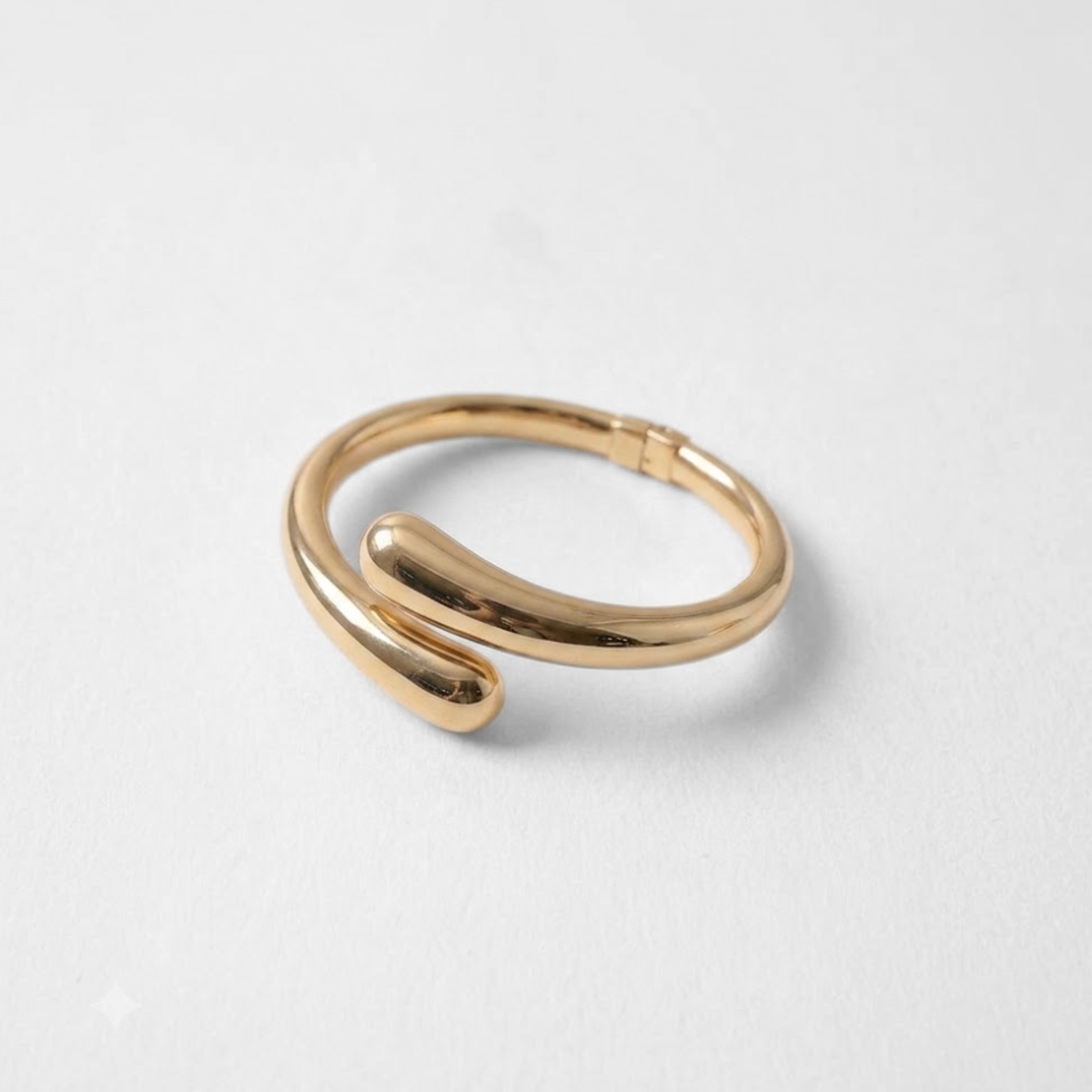 Close up of polished gold dome cuff bracelet showing smooth rounded silhouette, sculptural curves and contemporary jewelry design