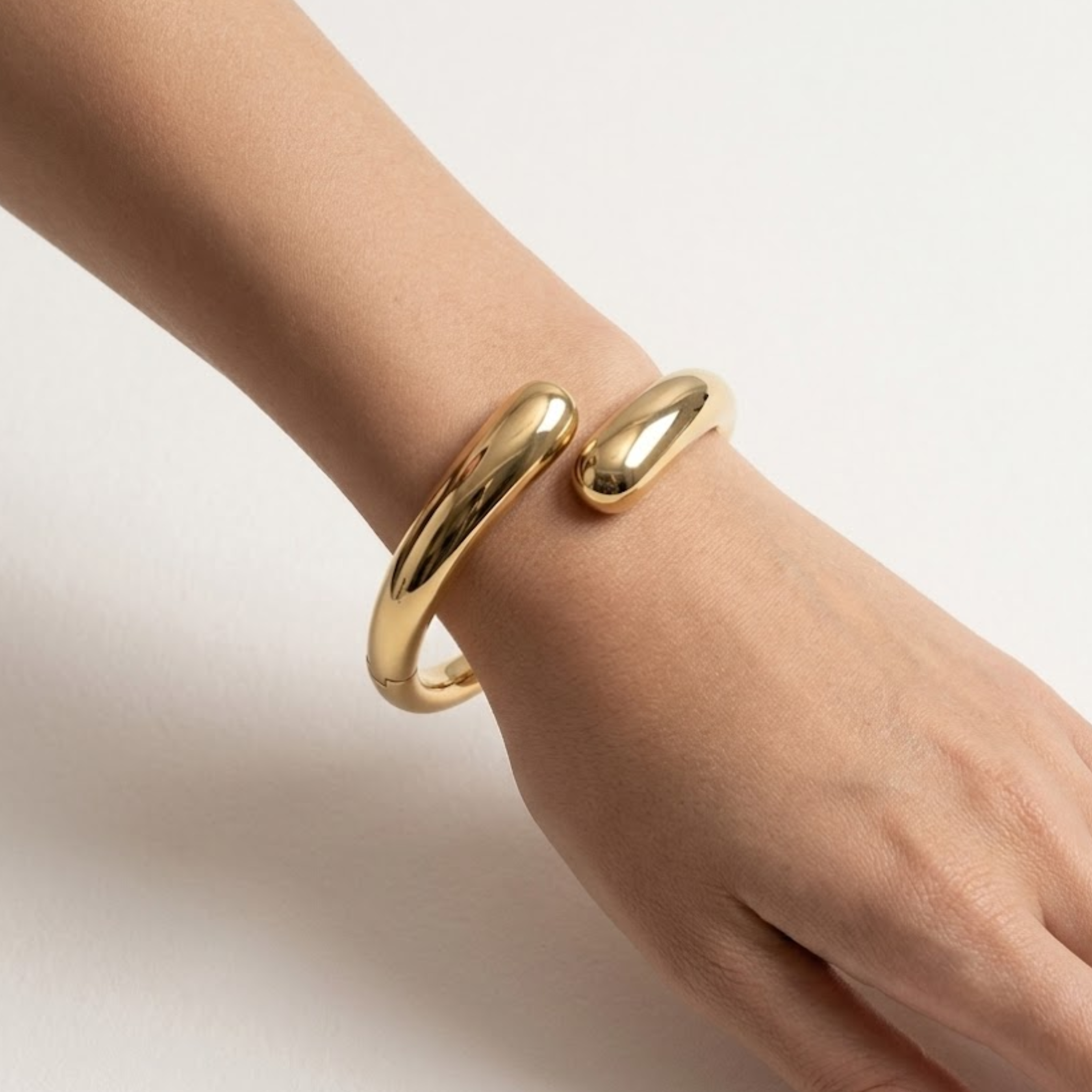 Chunky gold open bangle bracelet for layering with other gold jewelry, perfect for quiet luxury style and elevated everyday wear