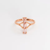 Close-up of a rose gold engagement ring with a round center diamond on a velvet cushion