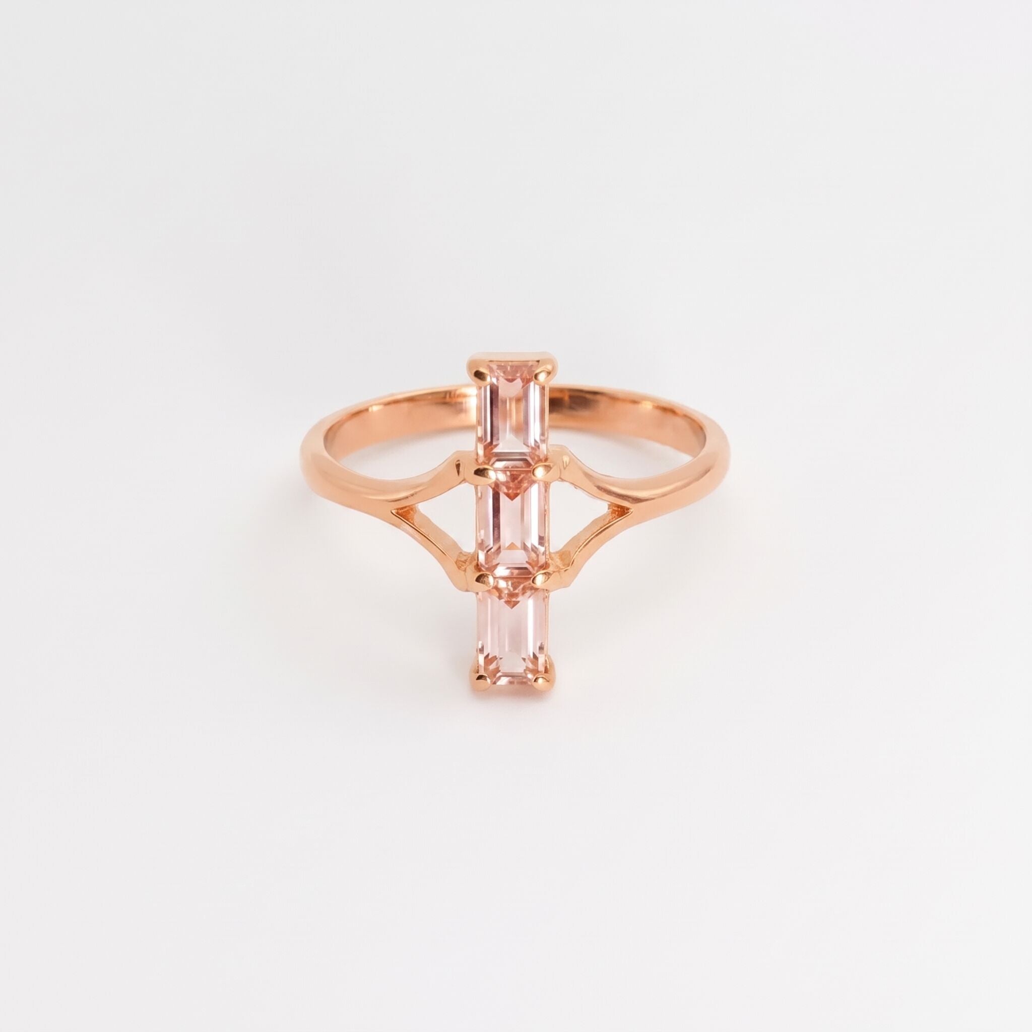 Close-up of a rose gold engagement ring with a round center diamond on a velvet cushion