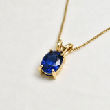 Delicate 18k gold vermeil pendant with oval created sapphire — symbolizes sincerity and faithfulness; great for birthdays