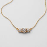 14k yellow gold necklace with natural white diamond in prong setting, April birthstone symbolizing commitment and purity.