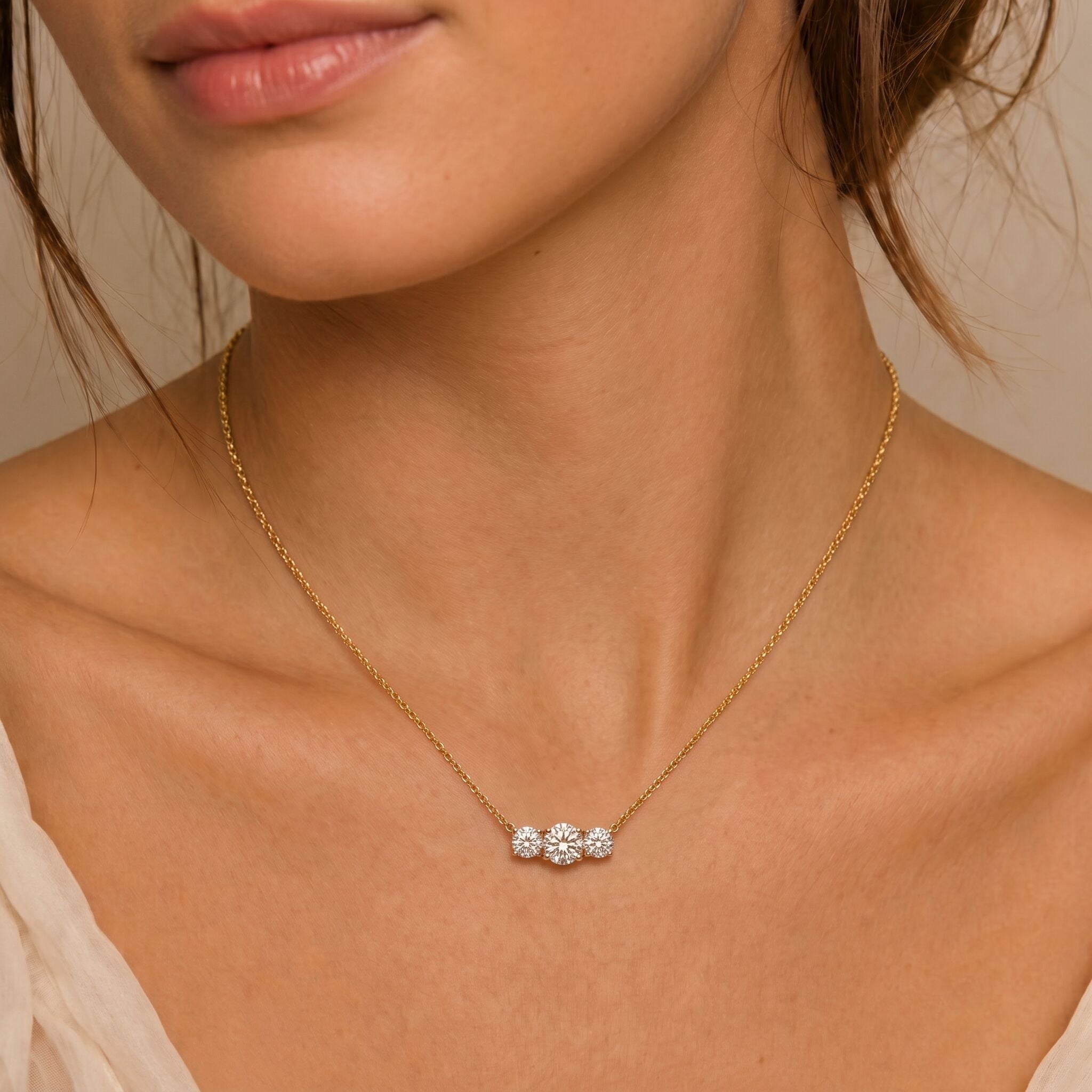 Close-up of 14k yellow gold necklace with natural white diamond in prong setting, April birthstone gift