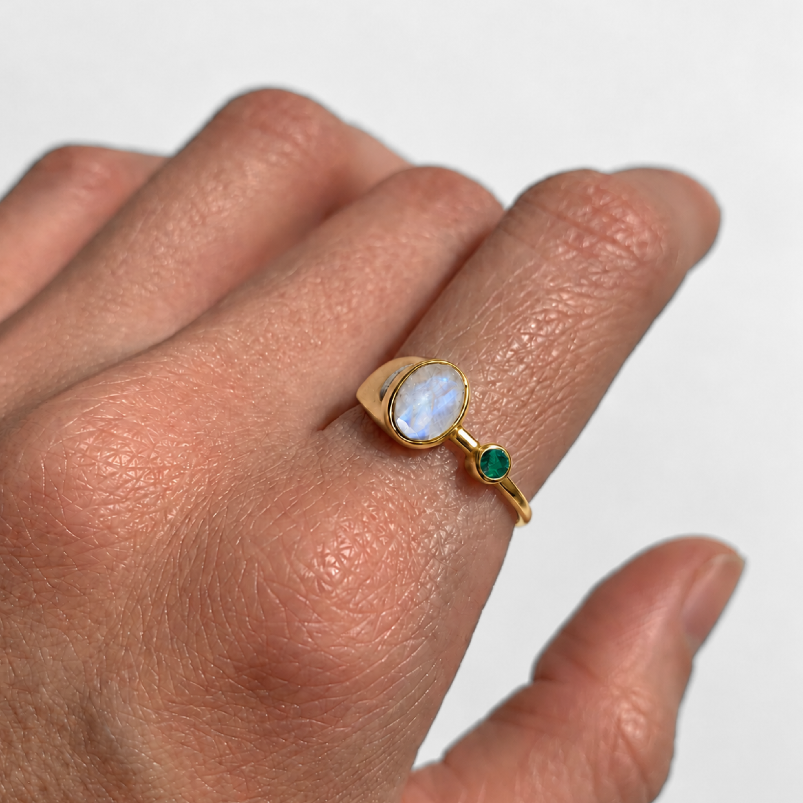 Close-up of oval rainbow moonstone bezel ring in 18k gold vermeil, June birthstone gift.