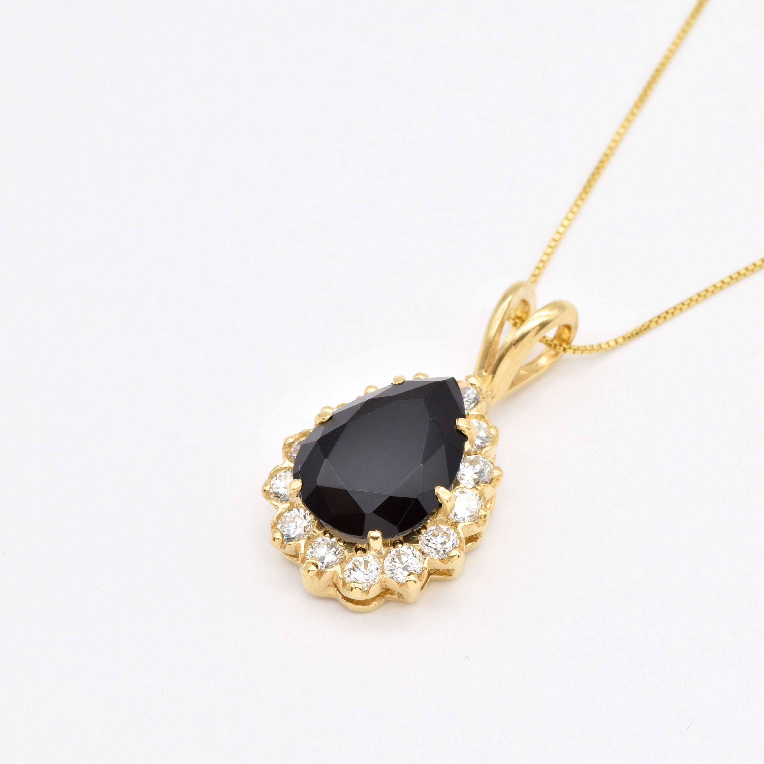This Onyx Pendant features a 9 Ct stone with golden brilliance for timeless appeal.