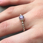 Amethyst Ring worn on middle finger with bare nails in a bubble band design, perfect for adding calm elegance to the outfit. This sterling silver tennis ring style enhances confidence and balance, making it ideal for office days, coffee meetups, and casual outings.