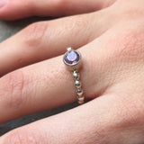 Amethyst Ring worn on middle finger with bare nails in a bubble band design, perfect for adding calm elegance to the outfit. This sterling silver tennis ring style enhances confidence and balance, making it ideal for office days, coffee meetups, and casual outings.