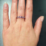 Amethyst Half Eternity Ring worn with light pink manicure, sterling silver row design that adds elegance and dainty charm, meaningful February birthstone for protection and clarity, suitable for date nights, weddings, and milestone celebrations.