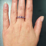 Amethyst Half Eternity Ring worn with light pink manicure, sterling silver row design that adds elegance and dainty charm, meaningful February birthstone for protection and clarity, suitable for date nights, weddings, and milestone celebrations.