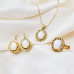 Natural Opal ring in gold with a halo of sparkling diamonds, featuring a cabochon cut gemstone for an elegant and timeless style. Known for promoting creativity and emotional balance, Opal is the October birthstone and makes a thoughtful gift for birthdays, anniversaries, weddings, or milestone celebrations.