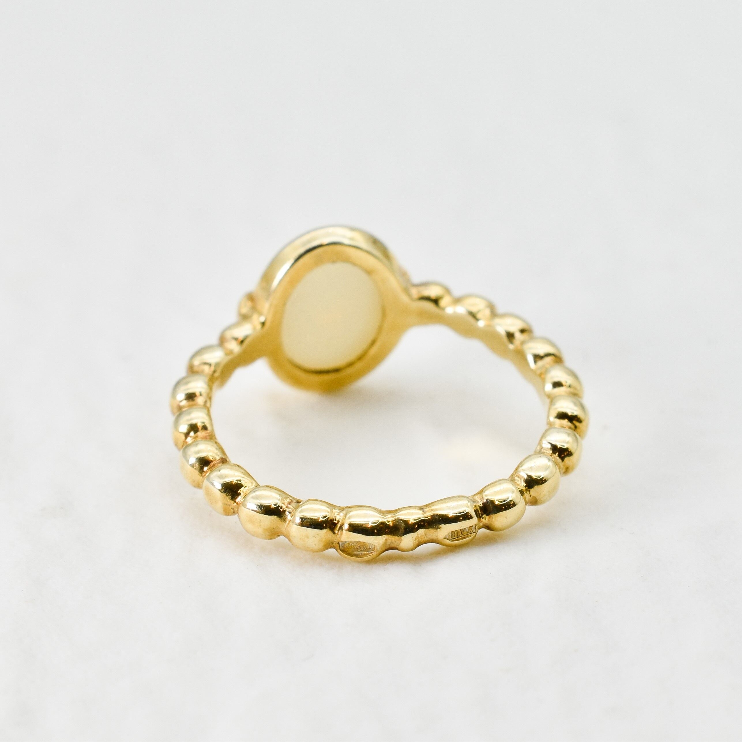 Natural Opal beaded gold ring with a smooth cabochon cut gemstone, offering a minimalist yet elegant style perfect for everyday wear. Opal, the October birthstone, is believed to inspire creativity and emotional balance, making it a meaningful gift for birthdays, anniversaries, weddings, and milestone celebrations.
