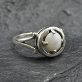 Australian Opal Ring in sterling silver featuring a round cabochon cut opal with flashes of fire colors. Australian opal is linked to creativity, inspiration, and emotional balance, making it a meaningful October birthstone gift. A thoughtful choice for birthdays, anniversaries, engagements, or promise rings. Perfect for daily wear, weddings, and elegant evening occasions.