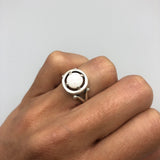 Australian Opal Round Ring worn on ring finger with natural nails. The cabochon opal displays flashes of fire colors set in sterling silver. A meaningful October birthstone piece perfect for birthdays, anniversaries, and promise occasions. Suitable for weddings, dinners, and elegant gatherings.