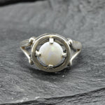 Australian Opal Ring in sterling silver featuring a round cabochon cut opal with flashes of fire colors. Australian opal is linked to creativity, inspiration, and emotional balance, making it a meaningful October birthstone gift. A thoughtful choice for birthdays, anniversaries, engagements, or promise rings. Perfect for daily wear, weddings, and elegant evening occasions.