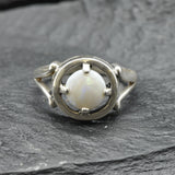 Australian Opal Ring in sterling silver featuring a round cabochon cut opal with flashes of fire colors. Australian opal is linked to creativity, inspiration, and emotional balance, making it a meaningful October birthstone gift. A thoughtful choice for birthdays, anniversaries, engagements, or promise rings. Perfect for daily wear, weddings, and elegant evening occasions.