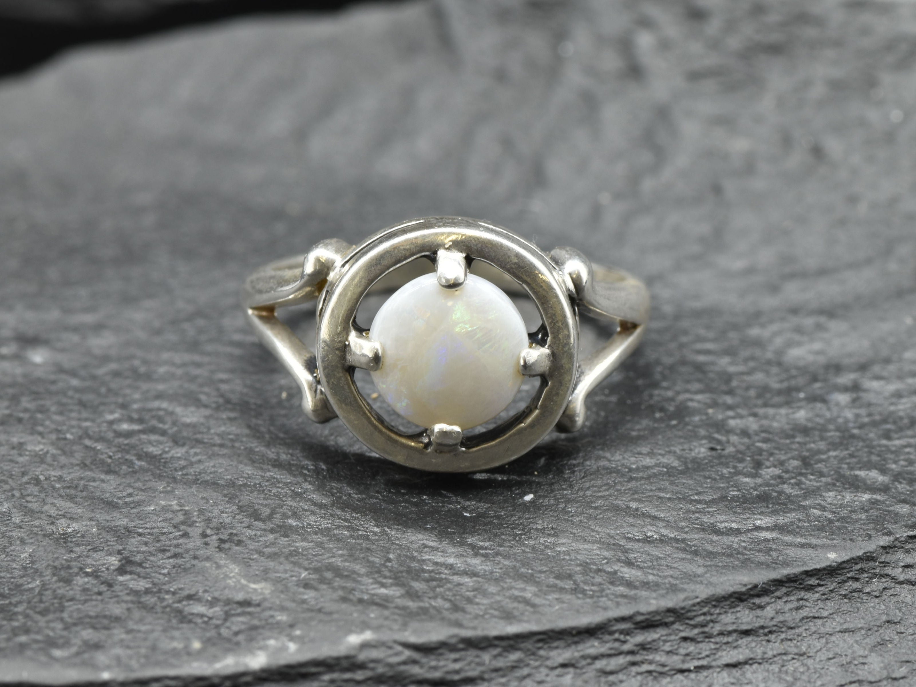 Australian Opal Ring in sterling silver featuring a round cabochon cut opal with flashes of fire colors. Australian opal is linked to creativity, inspiration, and emotional balance, making it a meaningful October birthstone gift. A thoughtful choice for birthdays, anniversaries, engagements, or promise rings. Perfect for daily wear, weddings, and elegant evening occasions.