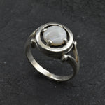 Australian Opal Ring in sterling silver featuring a round cabochon cut opal with flashes of fire colors. Australian opal is linked to creativity, inspiration, and emotional balance, making it a meaningful October birthstone gift. A thoughtful choice for birthdays, anniversaries, engagements, or promise rings. Perfect for daily wear, weddings, and elegant evening occasions.