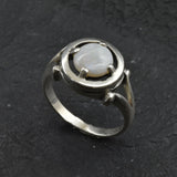 Australian Opal Ring in sterling silver featuring a round cabochon cut opal with flashes of fire colors. Australian opal is linked to creativity, inspiration, and emotional balance, making it a meaningful October birthstone gift. A thoughtful choice for birthdays, anniversaries, engagements, or promise rings. Perfect for daily wear, weddings, and elegant evening occasions.