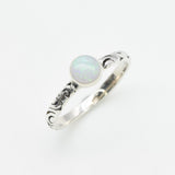 Bezel Opal ring with engraved silver band in a tribal boho style. The opal displays fire colors and flashing rainbow tones, symbolizing hope, creativity and emotional balance. A unique October birthstone gift perfect for anniversaries, festivals, weddings and special celebrations.