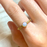 Bezel Opal Engraved Ring worn on ring finger with gold embossed tribal-style band and opal showing fire and rainbow colors. Perfect for adding boho elegance to festivals, date nights and October birthday celebrations.