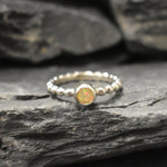 Yellow Fire Opal Bubble Band Ring in sterling silver with bezel set round cut, showcasing flashes of fire colors in a tennis band design for an elegant jewelry style. This durable and timeless piece is a meaningful October birthstone gift idea, symbolizing passion and inspiration. Ideal for birthdays, weddings, anniversaries, and evening occasions where a touch of unique brilliance is desired.