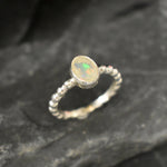 Fire Opal bezel bubble band ring in sterling silver with flashes of fire colors, a dainty jewelry style perfect for everyday elegance and stacking. Offers the benefit of durability with bezel setting and a glowing October birthstone gift idea for loved ones. Ideal to wear for birthdays, anniversaries, engagements, or casual celebrations.