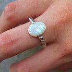 White Opal Ring worn on middle finger with nude nails, perfect for adding subtle elegance and calming energy, ideal for brunch dates or spring gatherings.
