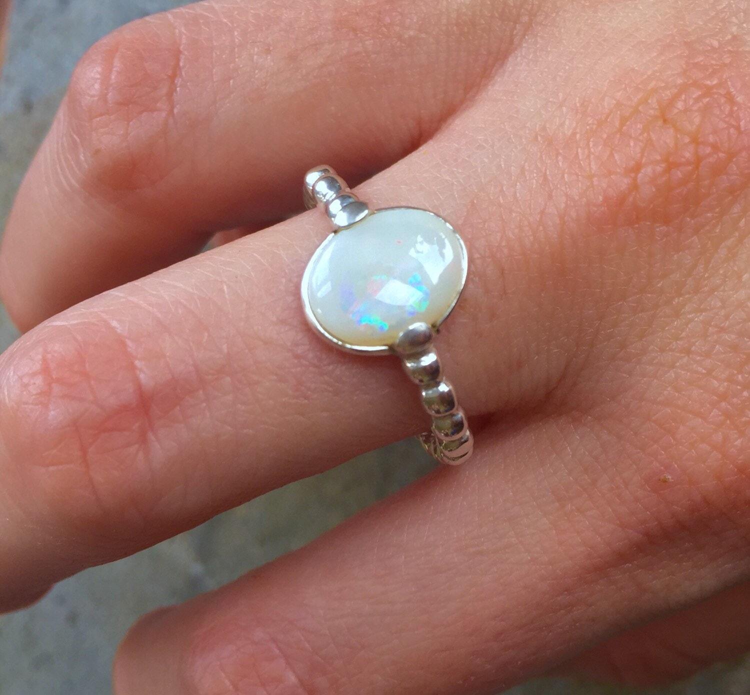 White Opal Ring worn on middle finger with nude nails, perfect for adding subtle elegance and calming energy, ideal for brunch dates or spring gatherings.